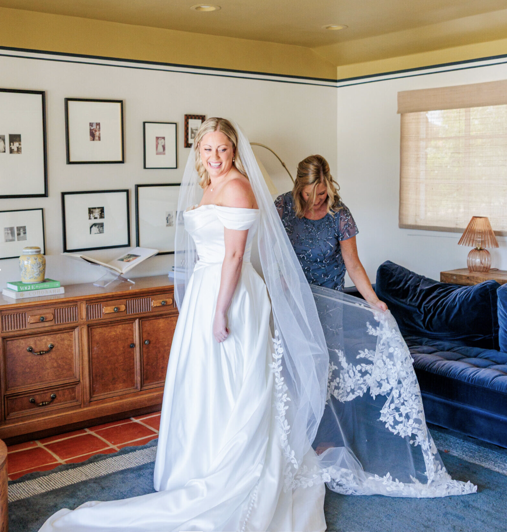 Bride getting ready with help inside the Wedding Cottage